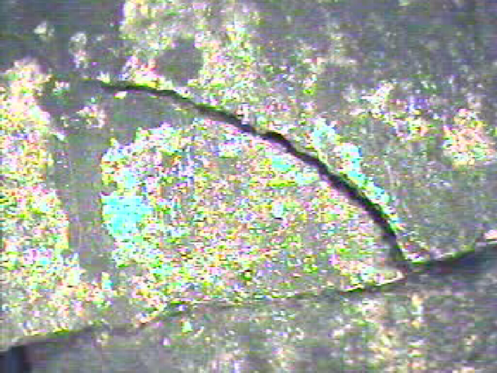 Image of cracked clay flue tile as seen with video inspection camera.